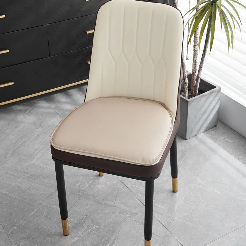 Leather horseshoe-shaped seat cushion in beige colour showing thickness and shape