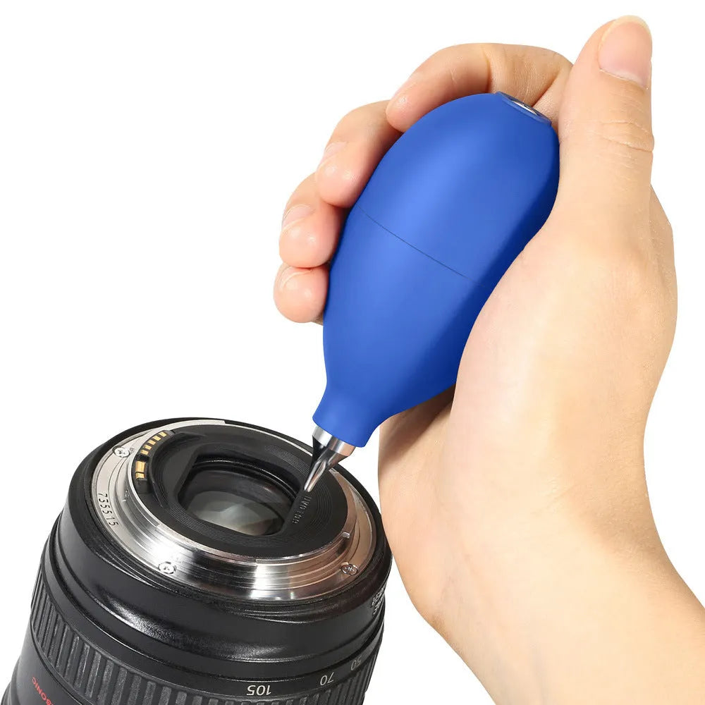 Blue handheld rubber dust blower cleaning tool for camera lenses and mobile phones.