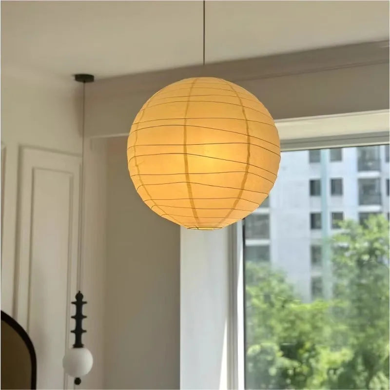 Japanese-style rice paper ball chandelier pendant light in a living room setting.