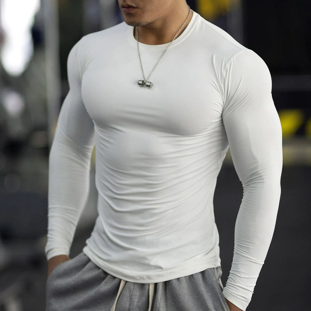 Man wearing black long-sleeved slim-fit fitness tights for running or gym workout