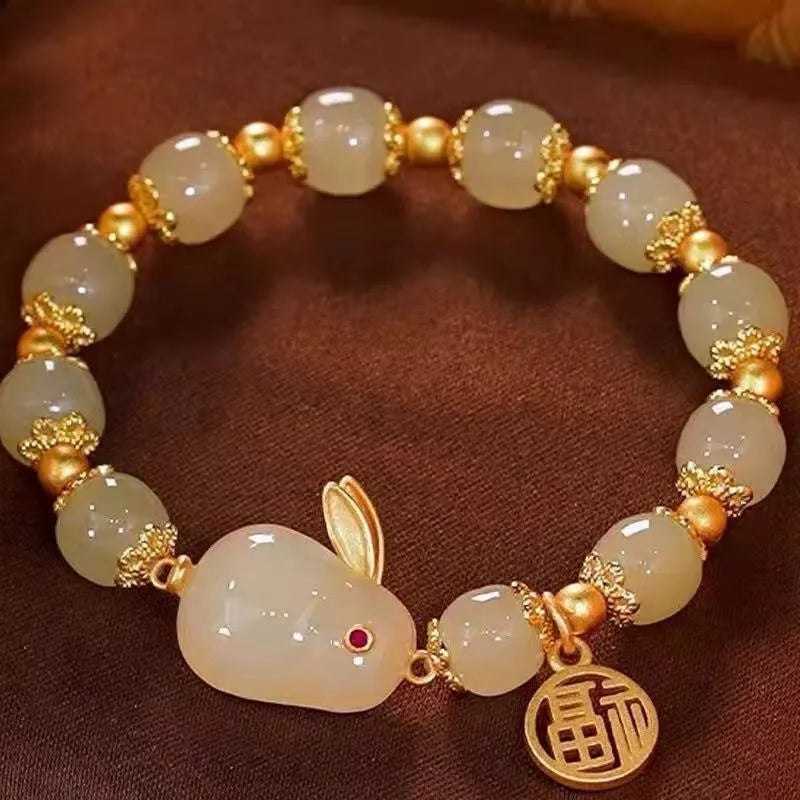 Green lucky bracelet with fu character charm, jade hare charm, and black bracelet base