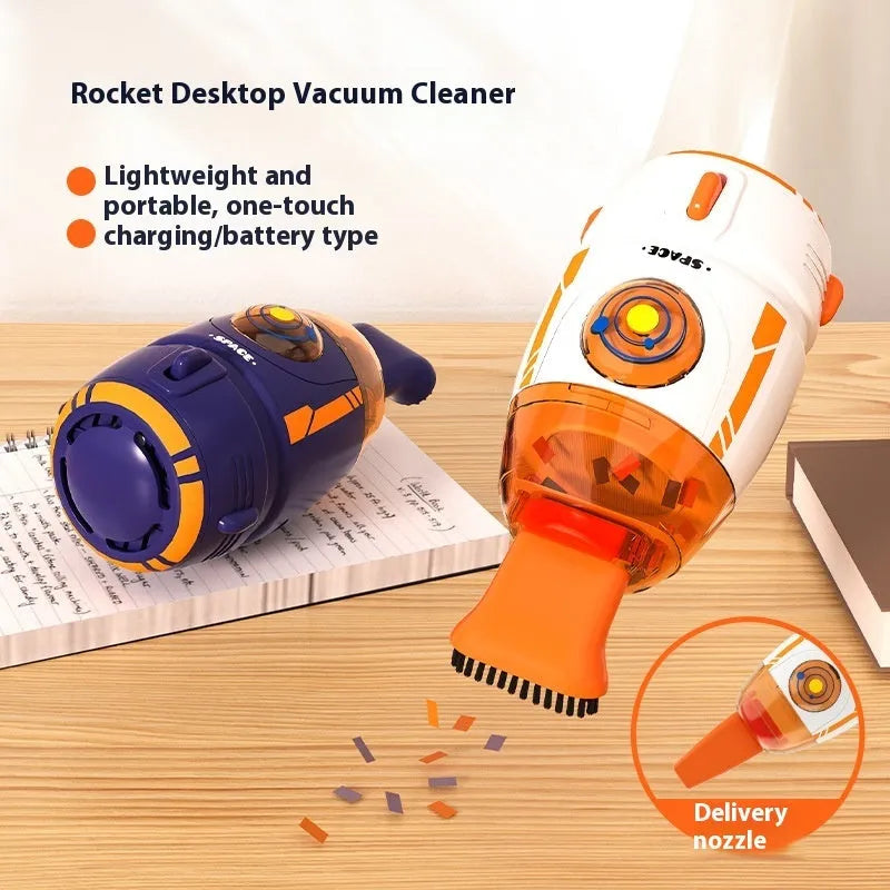 Handheld USB desktop vacuum cleaner in blue rocket design on a wooden desk next to a keyboard