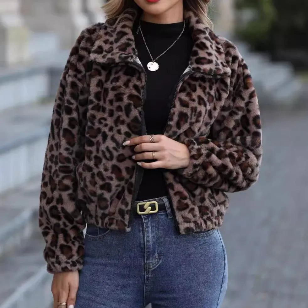 A woman's loose-fitting, zip-front plush coat in a leopard print pattern with raglan sleeves.