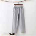 Men's beige pure cotton casual trousers with drawstring waist and belt on a neutral background.