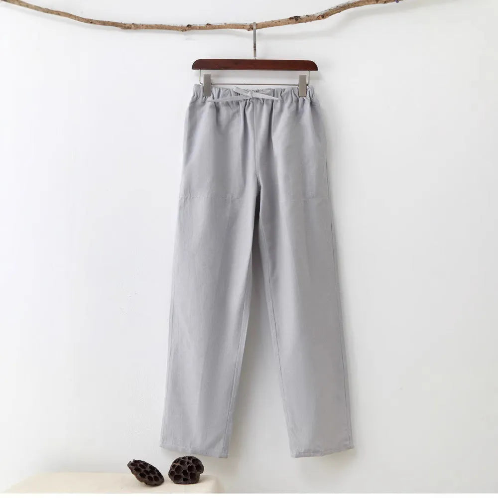 Men's beige pure cotton casual trousers with drawstring waist and belt on a neutral background.