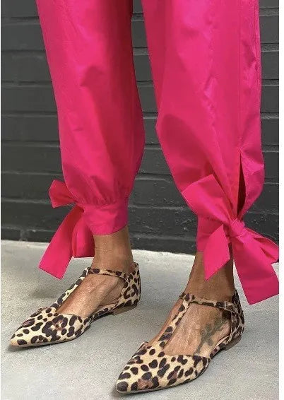 Leopard print women's pointed toe pumps with a low chunky heel and an ankle cross-strap.