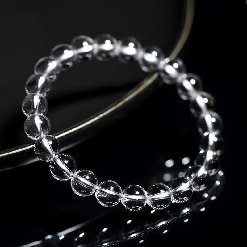 Natural Donghai white crystal round bead geometric bracelet on a wrist.
