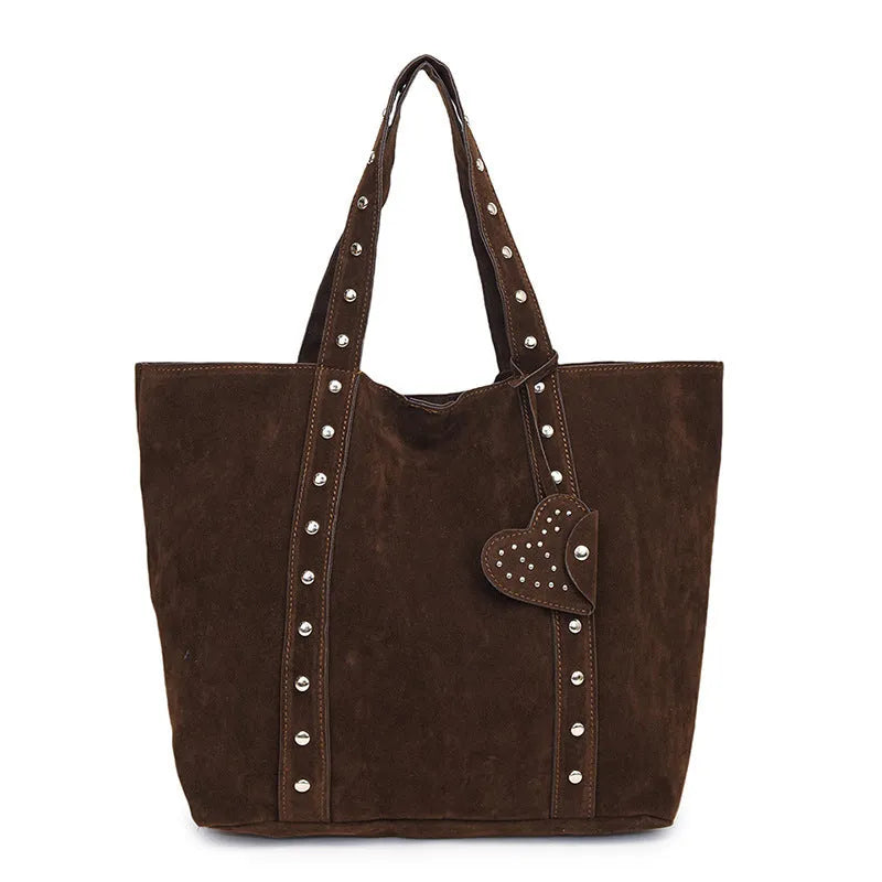 Black PU leather horizontal tote bag with double shoulder straps, showing outer sandwich pocket.