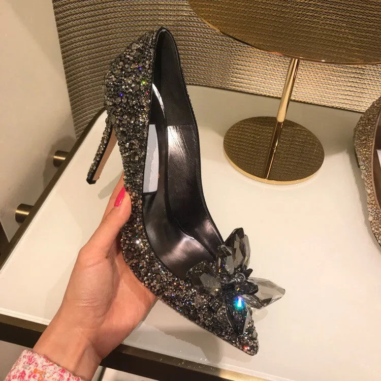 Gold women's pointed toe stiletto heels with rhinestone and sequin decoration on a 7cm heel.