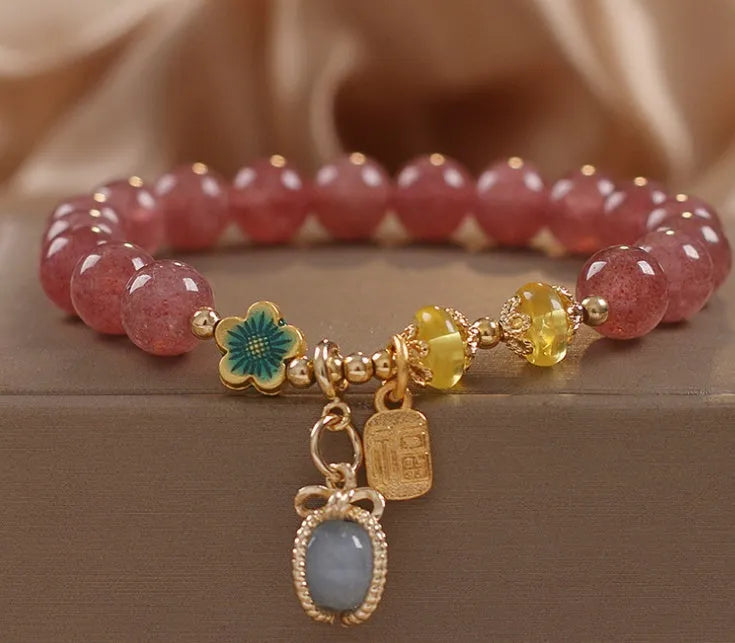 Red adjustable bracelet with strawberry quartz beads, alloy charm and rhinestone detailing