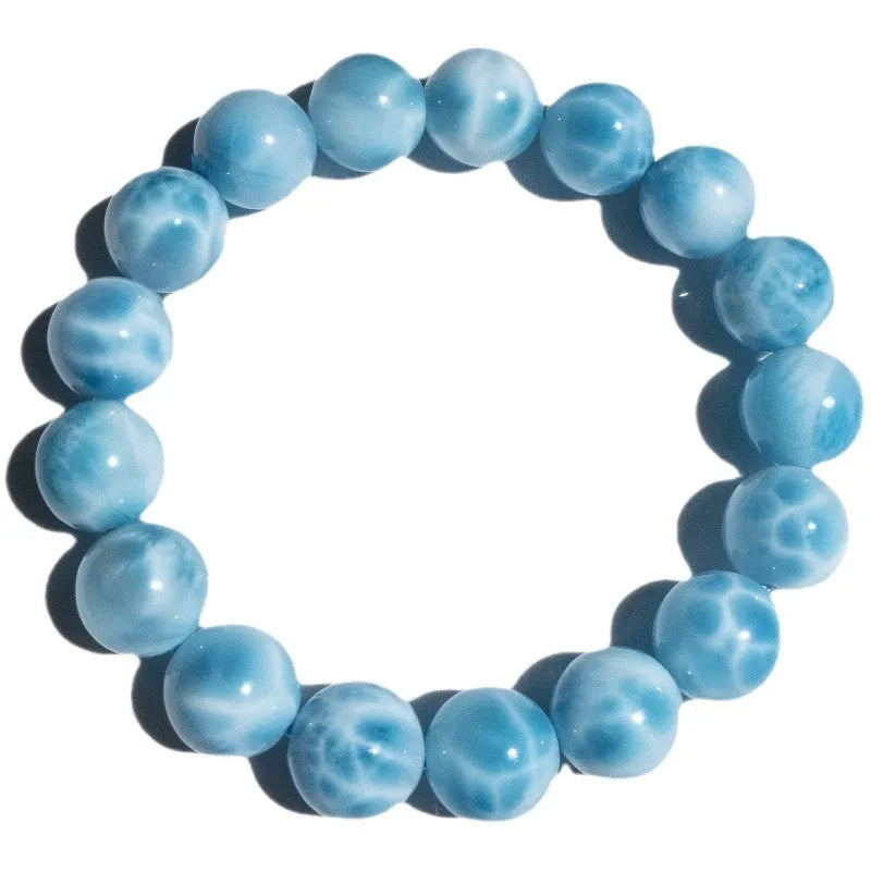 Blue handmade Bodhi bracelet with natural crystal, sea-pattern stone, and pearl in Maillard style.