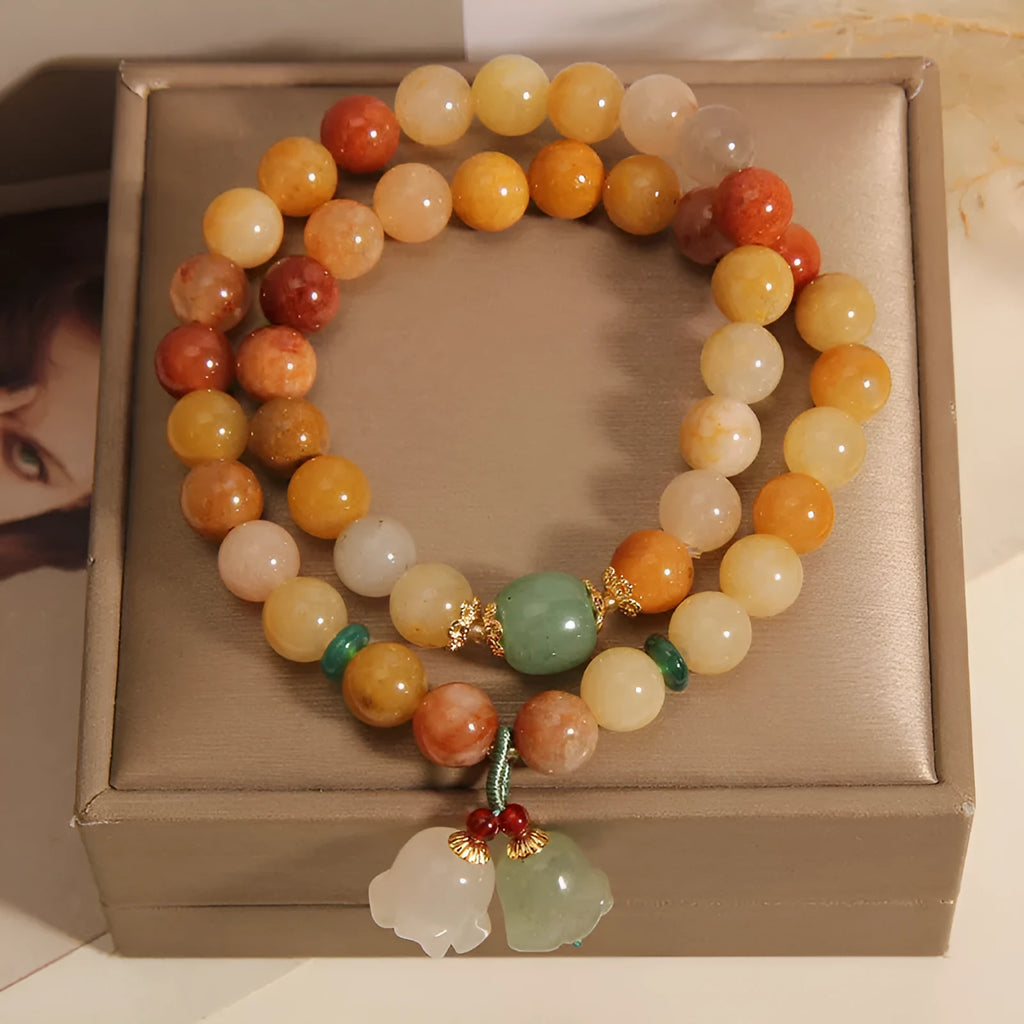 Natural jade multi-strand bracelet for women with an orchid pendant and adjustable clasp.
