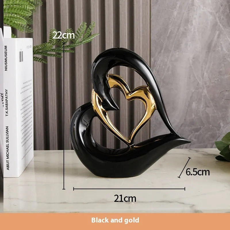 Modern geometric heart ornament in metallic finish displayed on shelf