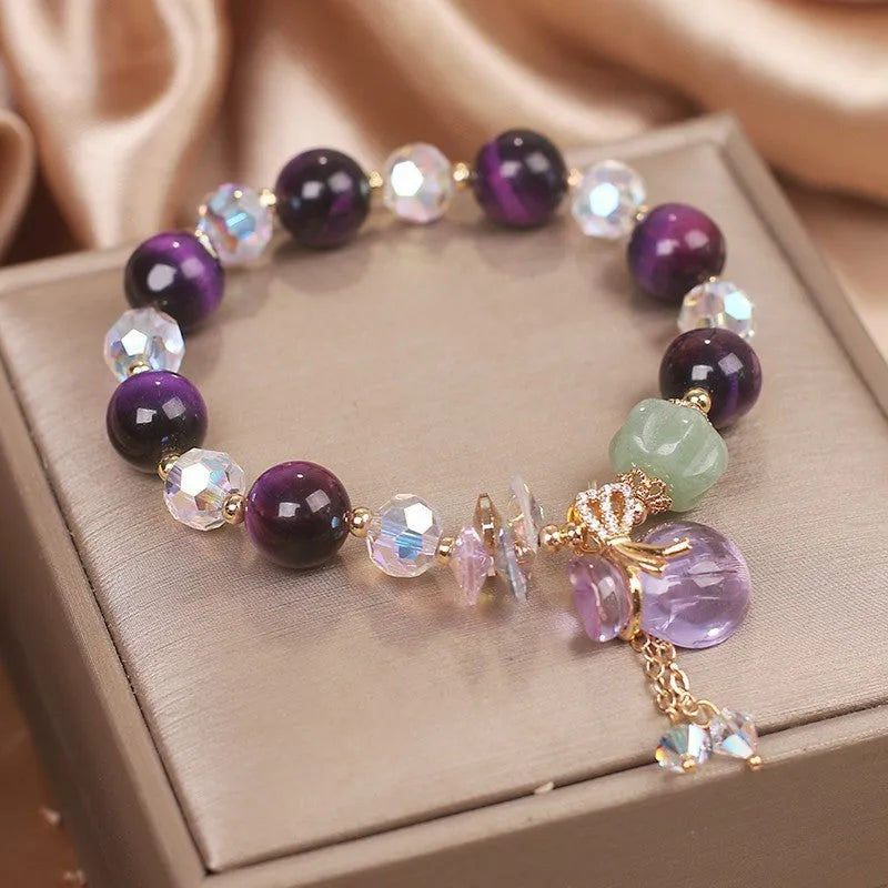 Women's forest style crystal bracelet with purple Tigereye money bag pendant and rhinestone details