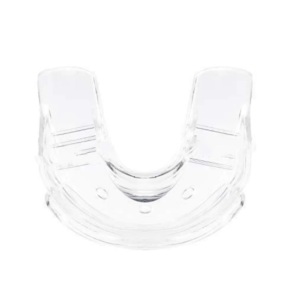 Transparent silicone denture model on a clean surface with natural light showing clear tooth structure