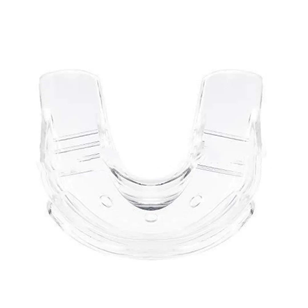 Transparent silicone denture model on a clean surface with natural light showing clear tooth structure
