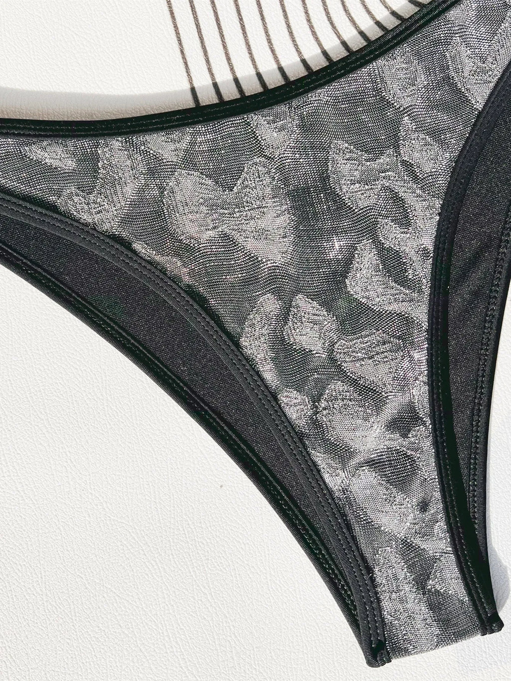 Women's black bikini set with strap design for swimming.