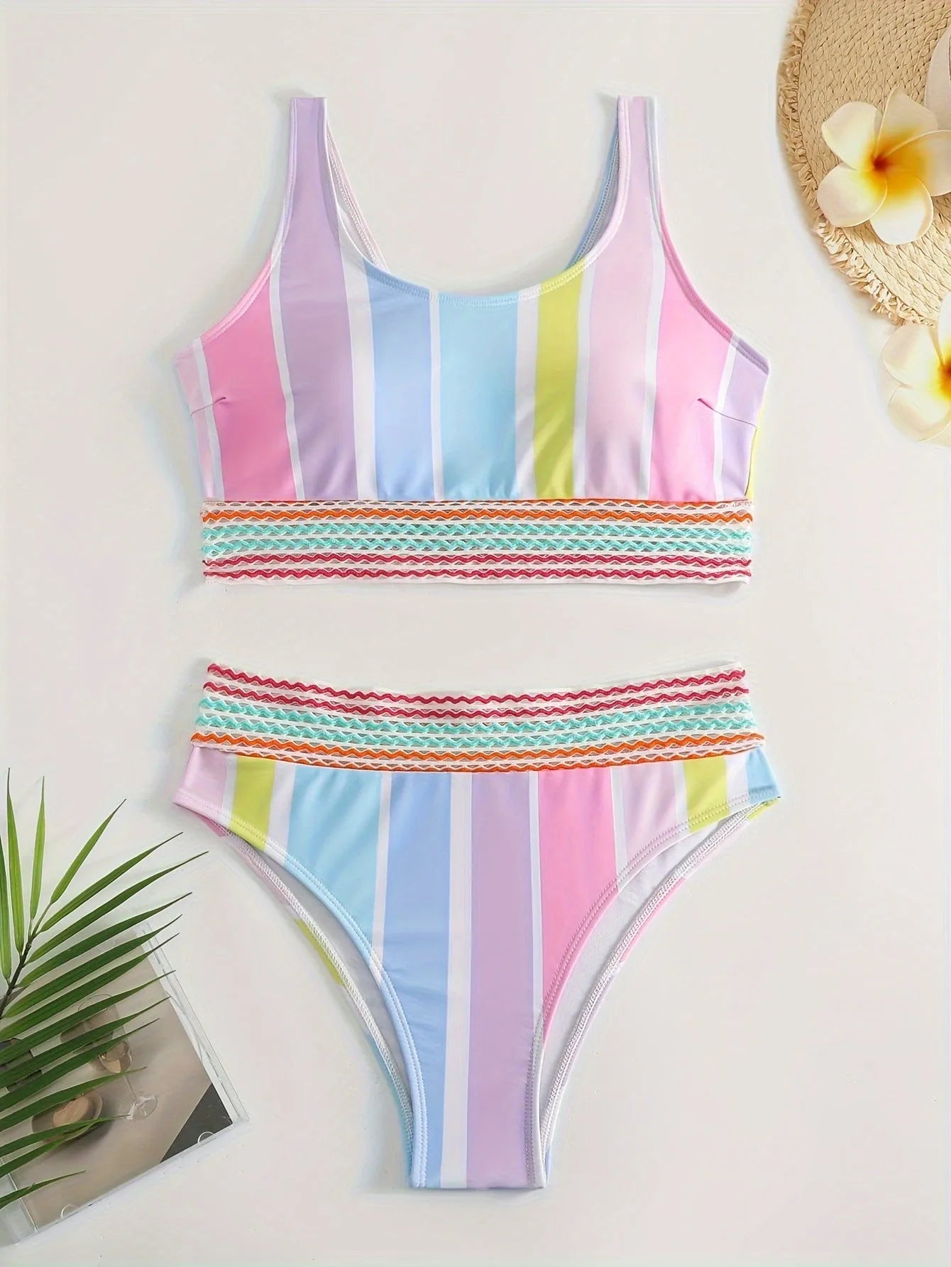 Women's striped two-piece bikini on a hanger, showing sporty briefs with spandex lining and matching top.