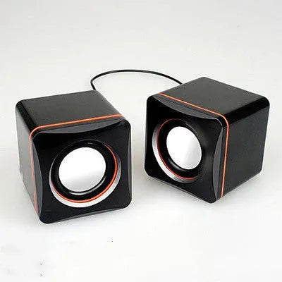 Small black square USB computer speaker model 700B on a desk.