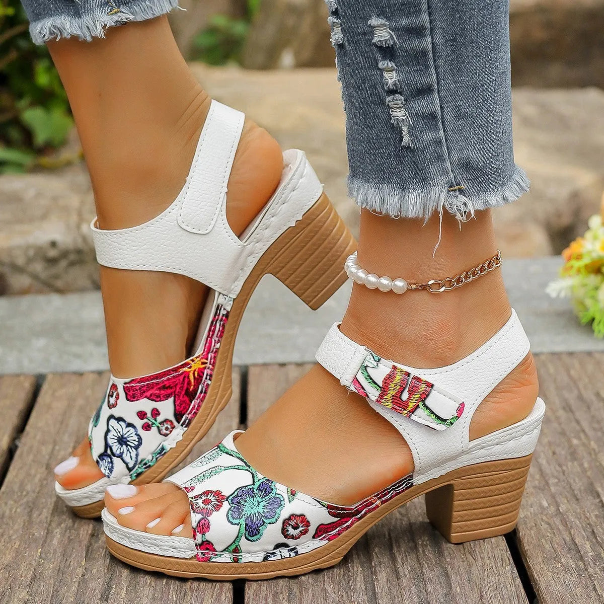 White women's high heel sandals with a Velcro strap buckle on the ankle.