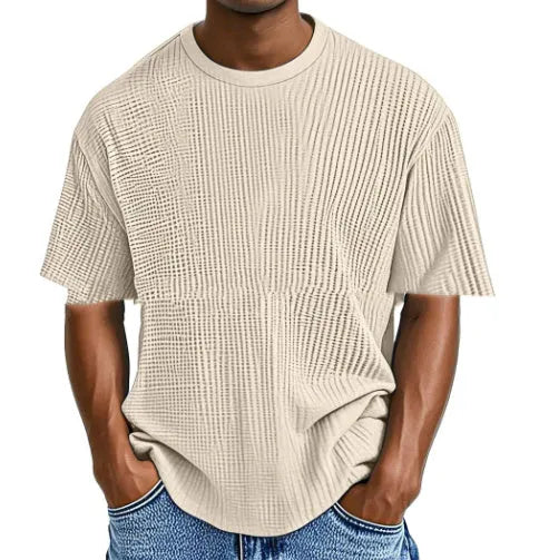 Man wearing a light blue waffle knit short sleeve cotton blend pullover, casual fit