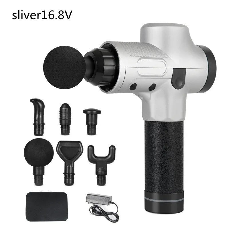 Black electric muscle massage gun with multiple attachment heads on a table.