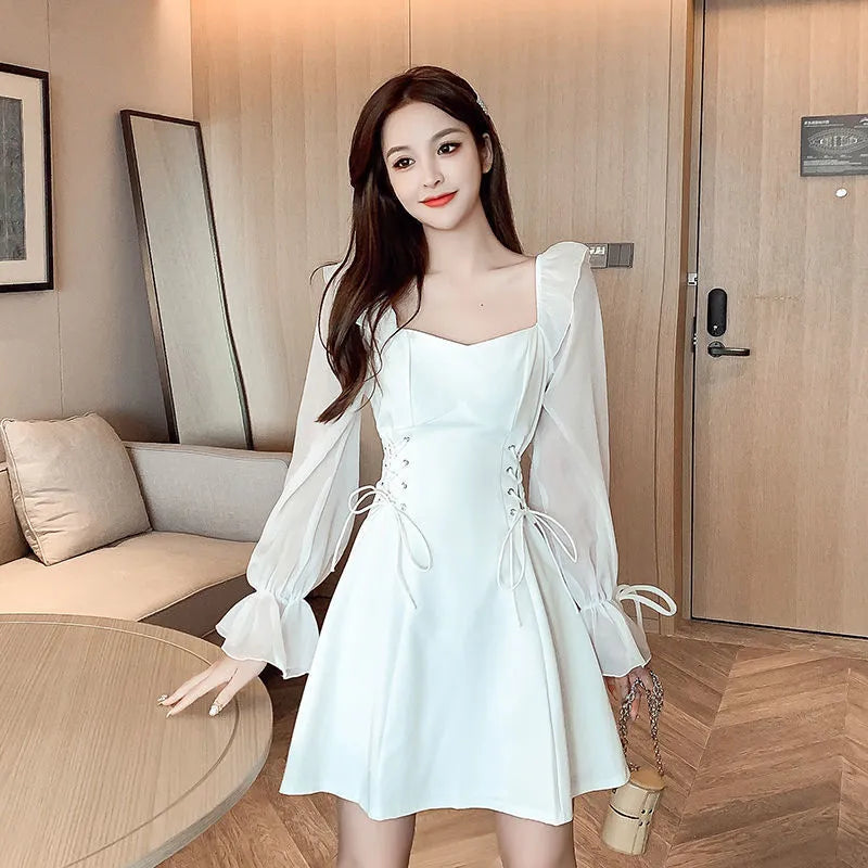 White chiffon patchwork dress with long sleeves and a waist-slimming fit on a mannequin.
