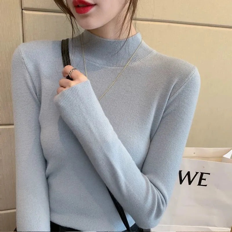 Slim fit apricot coloured viscose fibre knitted inner shirt with long sleeves laid flat.