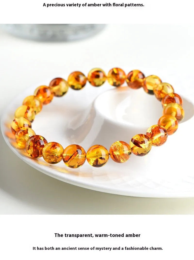 A geometric-bead amber bracelet with natural yellow piebald colouration on a wrist.