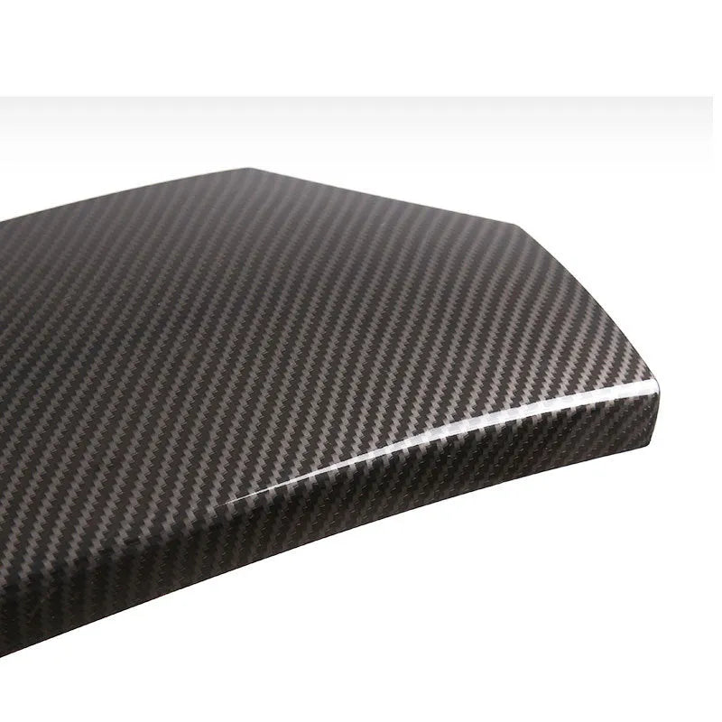 Three black ABS armrest box protective covers with a diagonal carbon fibre weave pattern.