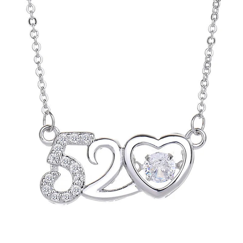 Silver heart pendant necklace with crown above and bow below on delicate chain