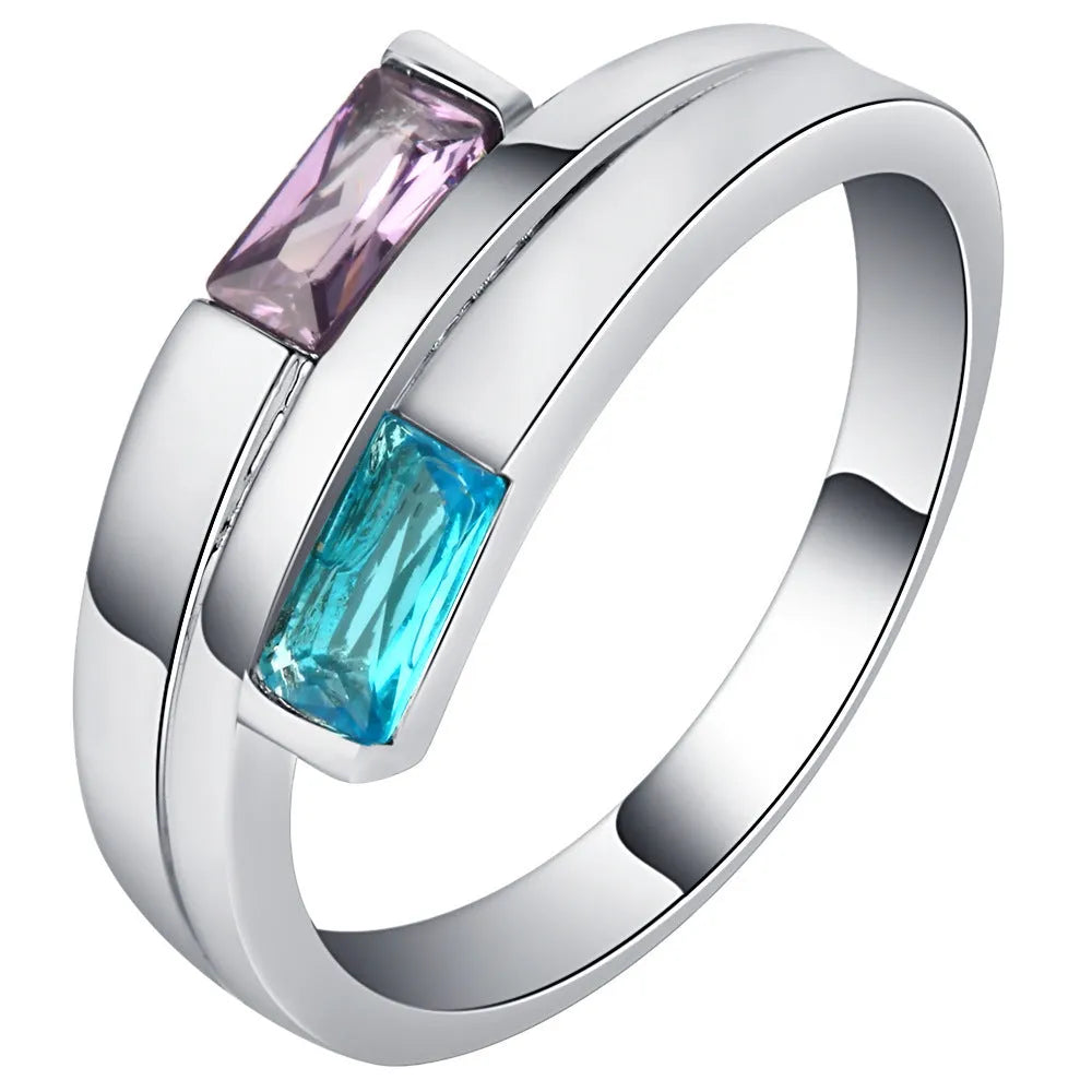 Copper ring with a silver electroplated finish and a central zircon stone, shown on a finger.