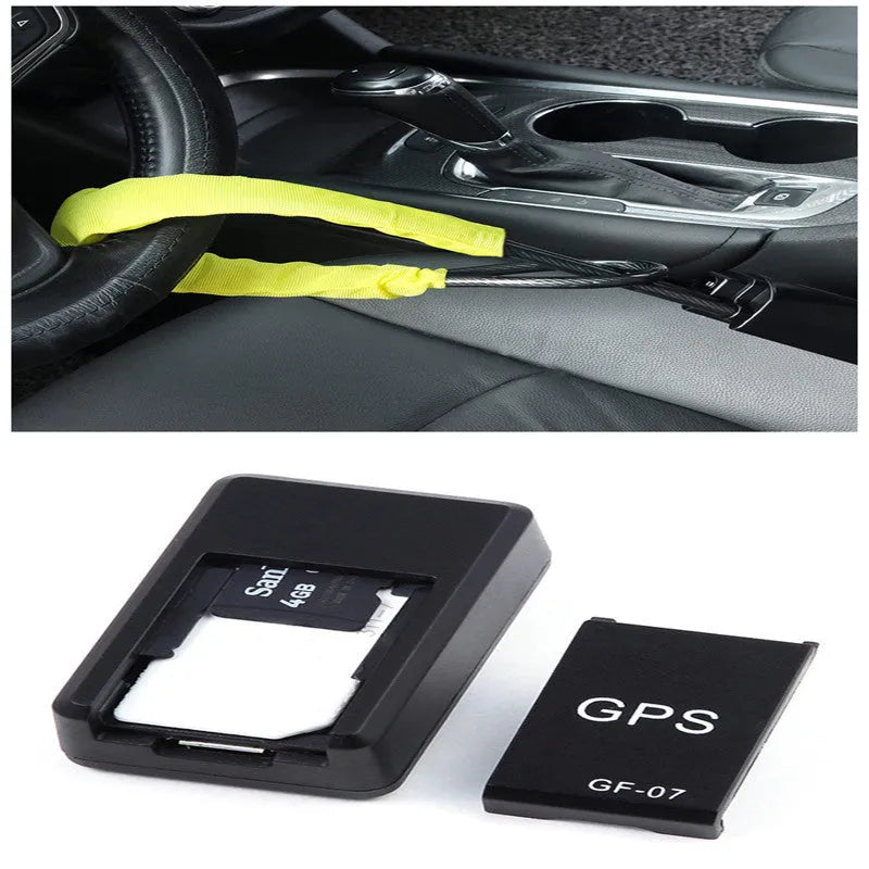 Small black magnetic GPS tracker device next to a USB charging cable on a table.