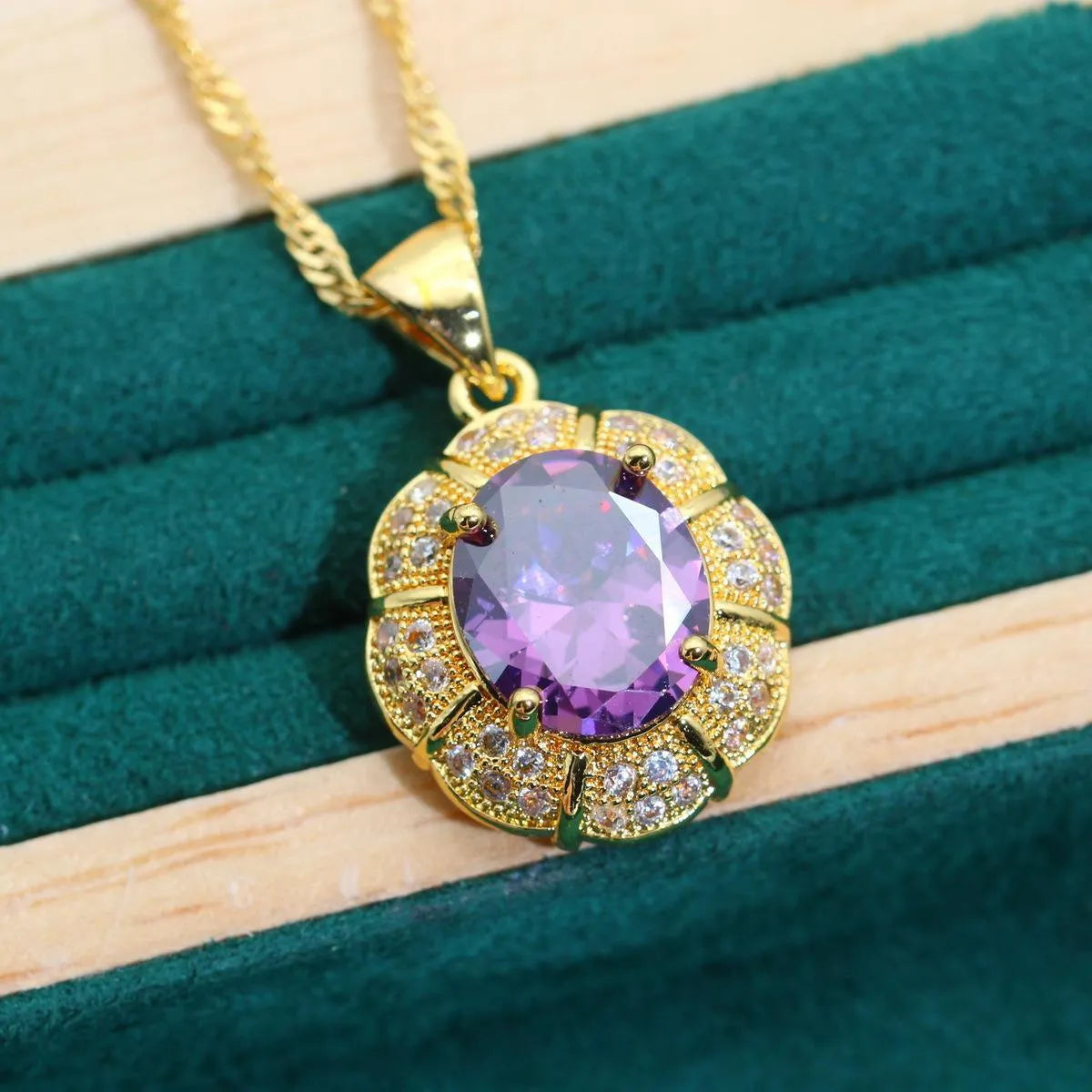 18k gold plated zircon jewellery set with necklace, earrings, ring, and bracelet on blue background