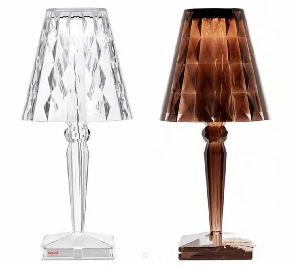 Rose gold portable touch projection night light on a surface, showing its acrylic body and dimming controls.