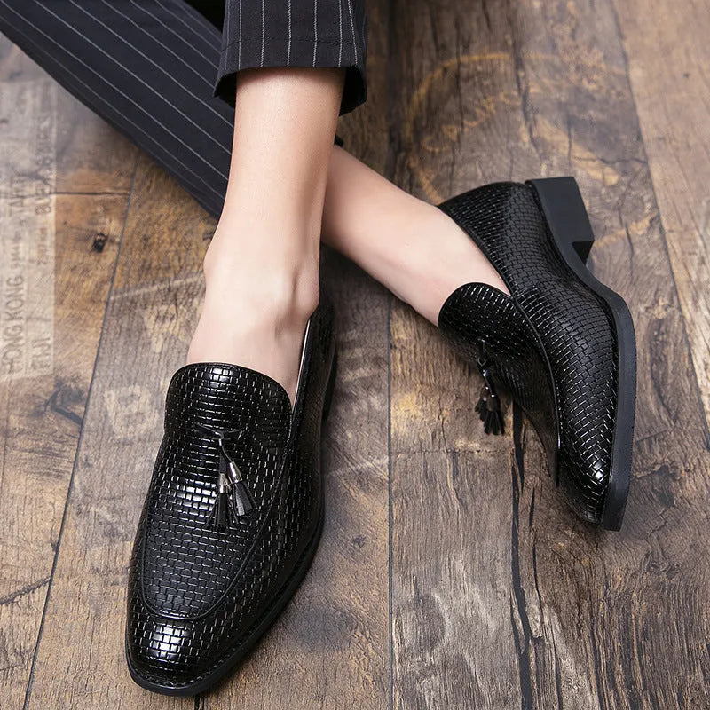 Men's black pointed toe slip-on shoe with a tassel on the low-top PU upper.