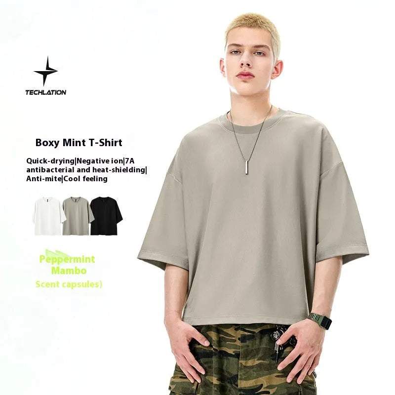 A sand grey men's loose fit short sleeve pullover made from a cotton and polyester blend fabric.