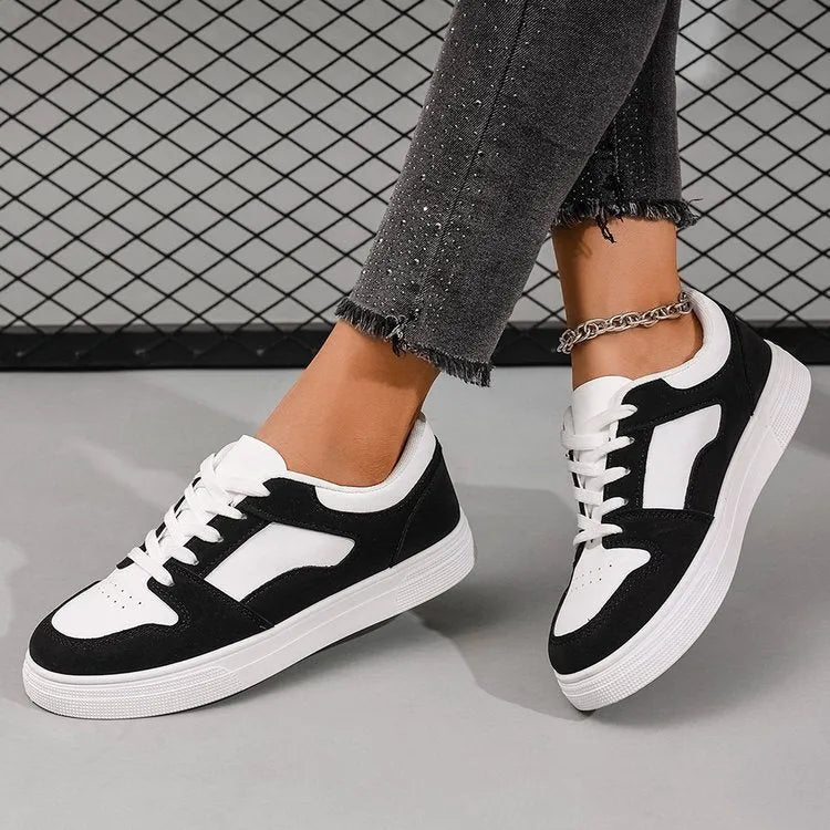 Black women's casual sports shoes with round toe, flat rubber sole, and lace-up front