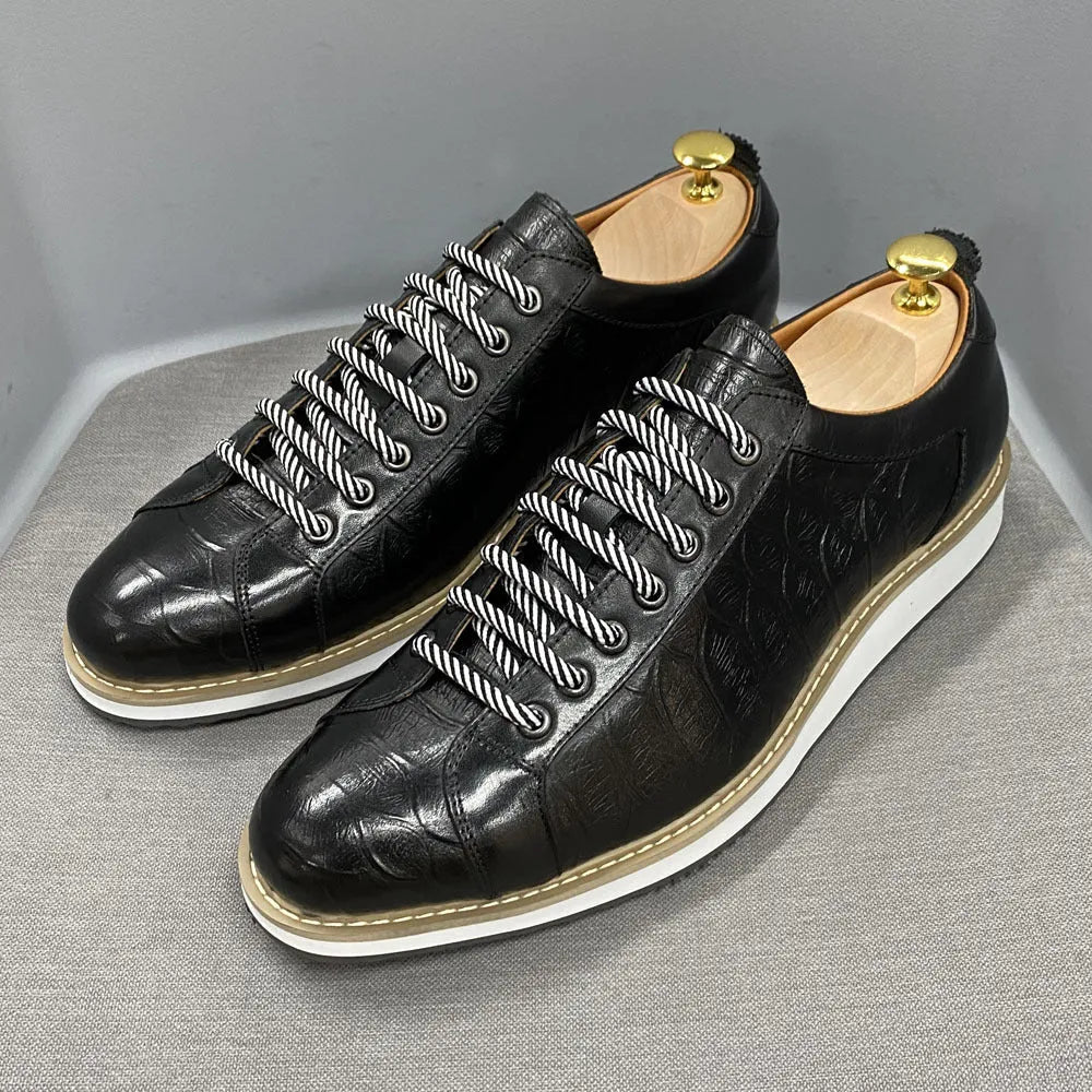 Men's low-top white shoes with embossed pattern texture on the front, featuring front-tie laces.