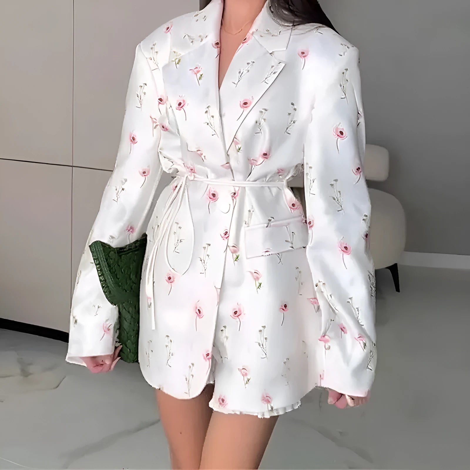 A printed suit jacket with a lace-up collar detail and waist-tightening feature on a mannequin.