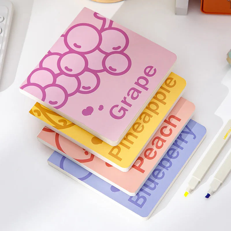 Square fruit-design notebook with 14.5cm sides, open to show 80g thick paper pages.