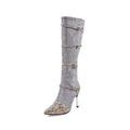 Grey and black women's knee-high boots with a thin high heel on a rubber sole.