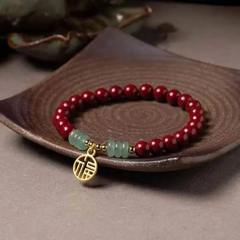 Handmade gold cinnabar wave bracelet showing genuine stone and copper bead construction in national style design