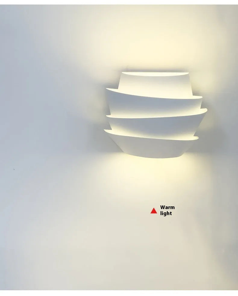 White modern wall lamp with pine cone silhouette design for bedroom or hallway lighting