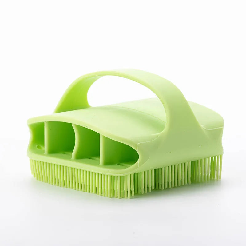 Blue silicone scalp massager brush with hand-strap handle for washing and massaging hair.