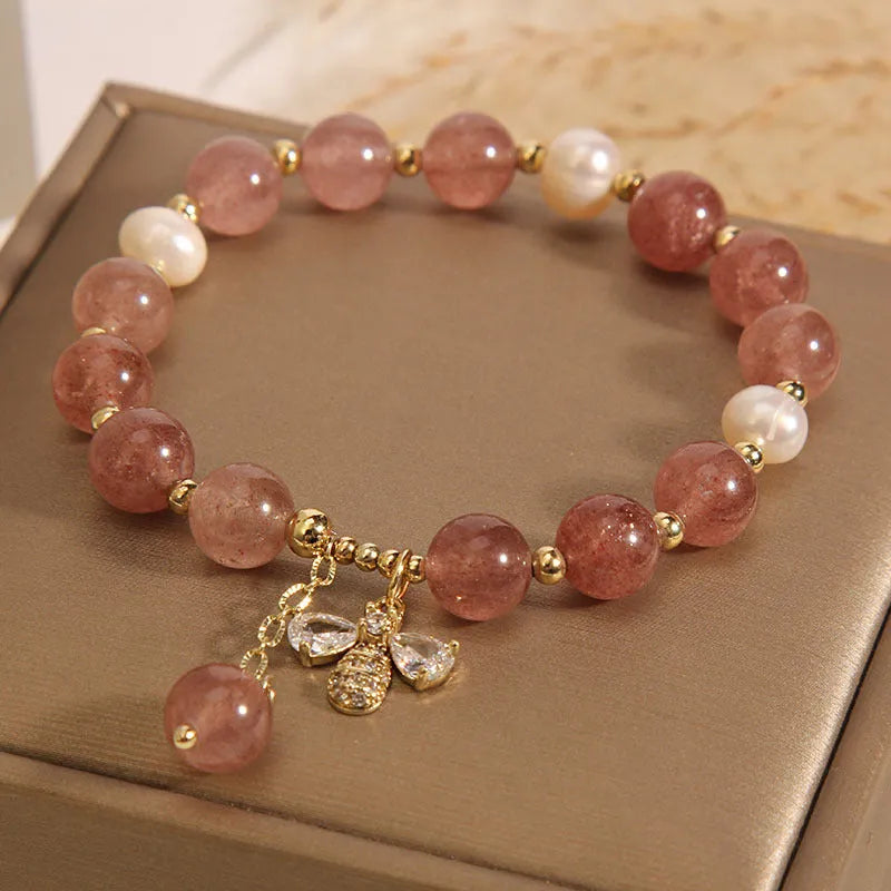 Women's bracelet with pink strawberry quartz stones, white freshwater pearls, and sparkling zircon on an alloy chain.