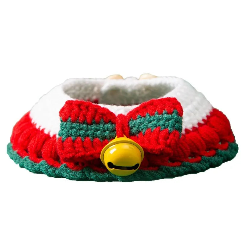 Hand-woven red and white Christmas bow knit collar scarf for a cat on a festive background.