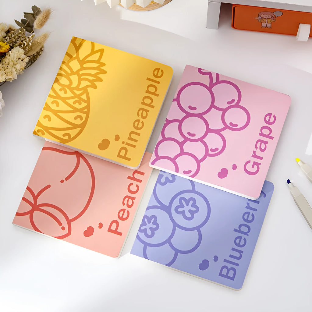 Square fruit-design notebook with 14.5cm sides, open to show 80g thick paper pages.