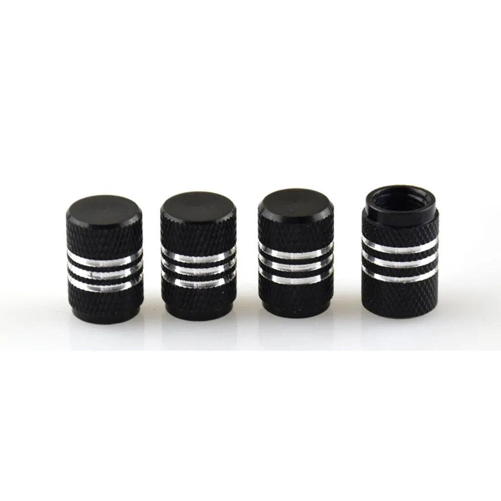 Assortment of aluminium alloy car tyre valve caps in ten different colours on a grey background.