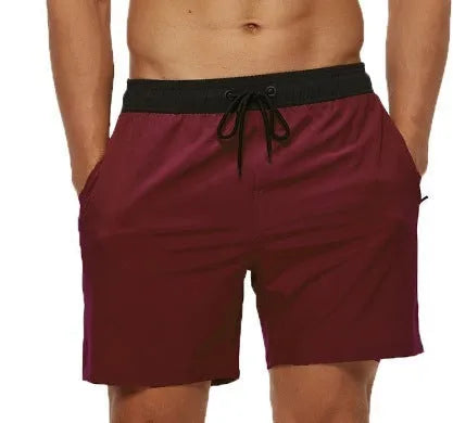 Men's blue fitness shorts with a drawstring waistband and a side zipper pocket.